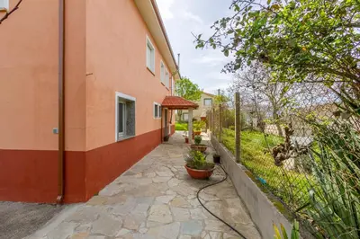a walkway next to a building with a fence at CASA NIDES in Doade