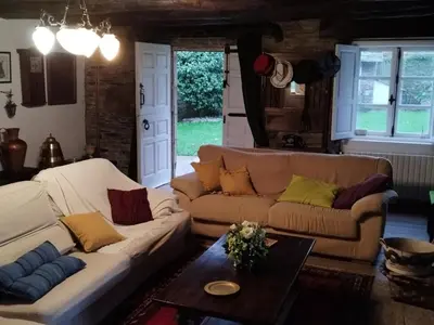 a living room with two couches and a table at Casa Oute in Sobrada