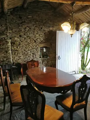 a dining room with a wooden table and chairs at Casa Oute in Sobrada