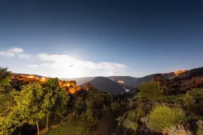 a view of a valley at night with the stars at Casa de lujo en la Ribeira Sacra in Acova