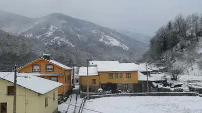 a group of houses with snow on the ground at CASA MUNIELLOS in Cangas del Narcea