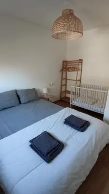 a bedroom with a bed with two towels on it at Morgon House in Molinaseca