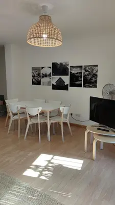 a dining room with a table and chairs and a chandelier at Morgon House in Molinaseca