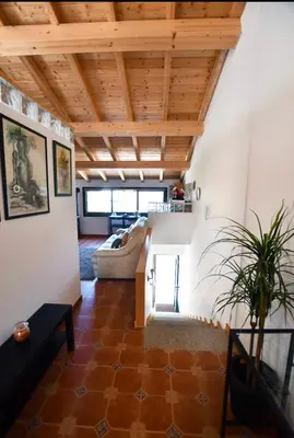 a living room with a wooden ceiling at Casa da Ponte in Monforte de Lemos