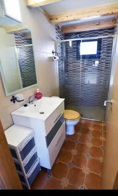 a bathroom with a white sink and a toilet at Casa da Ponte in Monforte de Lemos