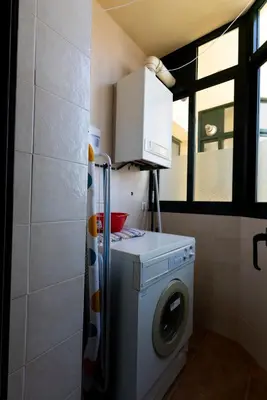 a washer and dryer in a small bathroom at Playa de Llas in Foz