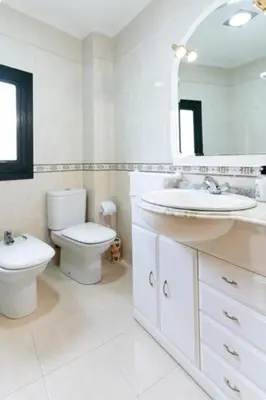 a bathroom with a toilet and a sink and a mirror at Playa de Llas in Foz