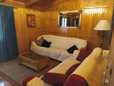 a living room with a couch and a table at Casas de madera 
