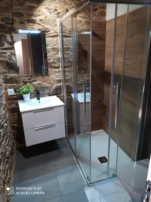 a bathroom with a shower and a sink at Albergue Atrio in Tríacastela