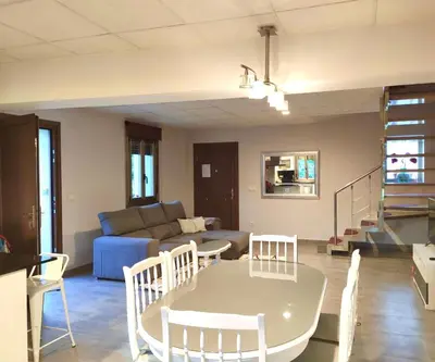 a living room with a table and a couch at Casa nueva con jardín y wifi en Ribeira Sacra in Castrelo