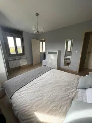 a bedroom with a large white bed and two windows at Casa nueva con jardín y wifi en Ribeira Sacra in Castrelo
