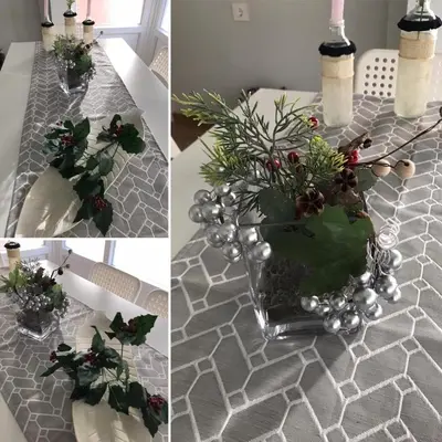 a table with a vase with christmas decorations on it at cuartin del camino in Ponferrada