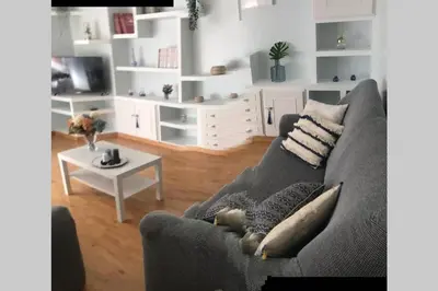 a living room with a gray couch and a table at cuartin del camino in Ponferrada