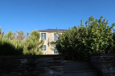 a brick house with bushes in front of it at A Palleira de Lola in Lugo