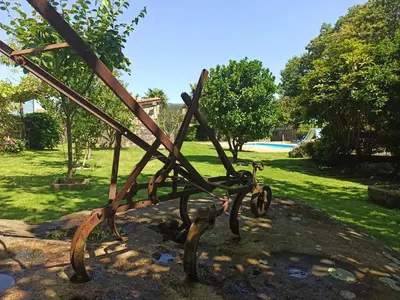 a metal sculpture in a park with a yard at Villageermis - Casa Rural in Moraña