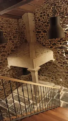 a stone wall with a stone cross on it at Villageermis - Casa Rural in Moraña