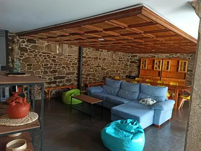 a living room with a blue couch and a table at Villageermis - Casa Rural in Moraña