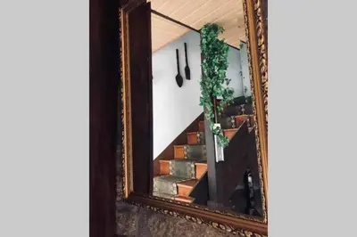 a mirror with a reflection of a stairway at CASA ALBA DE SAN ROMÁN in Ourense