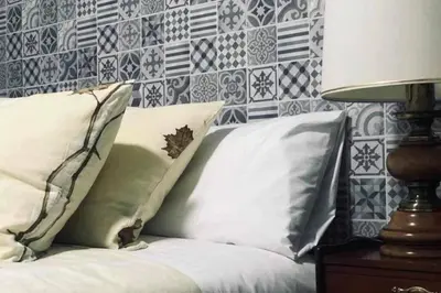 a bedroom with a bed with pillows and a lamp at CASA ALBA DE SAN ROMÁN in Ourense
