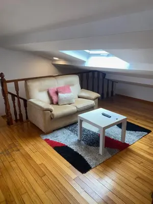 a living room with a couch and a table at Atico en el casco histórico in Santiago de Compostela