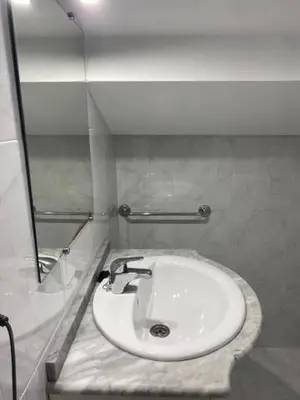 a bathroom with a white sink and a mirror at Atico en el casco histórico in Santiago de Compostela