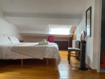 a bedroom with a bed and a skylight at Atico en el casco histórico in Santiago de Compostela