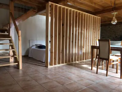 a room with a staircase and a bedroom with a bed at VUT Boente in Boente