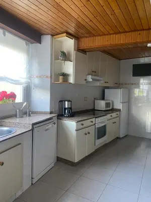 a kitchen with white appliances and a wooden ceiling at VUT Boente in Boente