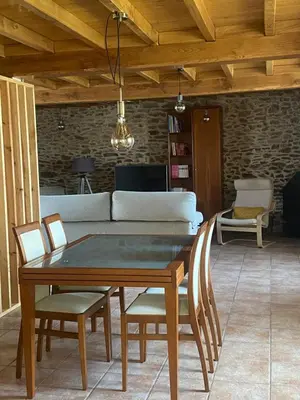 a table and chairs in a living room with a couch at VUT Boente in Boente