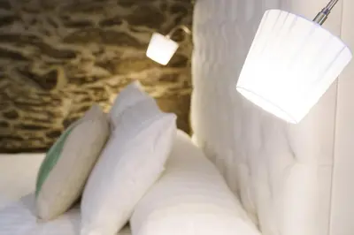 a white bed with pillows and a lamp on it at Lar da Mota Boutique Hotel in Arzúa