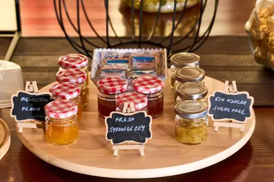 a tray with jars of honey on a table at Lar da Mota Boutique Hotel in Arzúa
