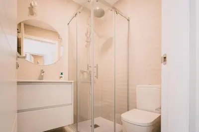 a bathroom with a shower and a toilet at Apartamentos Rúa Vella in Caldas de Reis