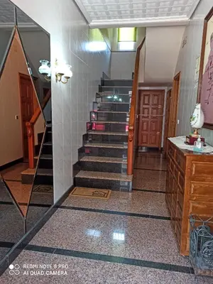 a hallway with stairs in a building at PENSION LA PARADA in Fabero