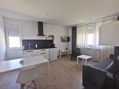 a kitchen and living room with a couch and a table at Seijo in Villalba