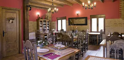 a dining room with a table and chairs in a restaurant at CASA ALTOBIERZO, 9 Habitaciones y 9 BAÑOS in Pobladura de las Regueras