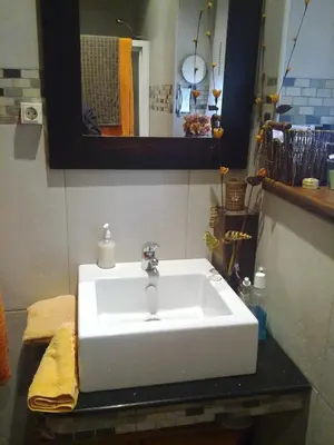 a bathroom with a white sink on a counter at CASA ALTOBIERZO, 9 Habitaciones y 9 BAÑOS in Pobladura de las Regueras