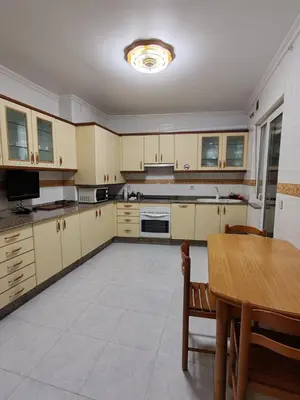 a large kitchen with a table and a dining room at Apartamentos Quien Anda Ahí Ribadeo in Ribadeo