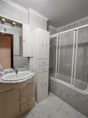 a bathroom with a sink and a shower at Apartamentos Quien Anda Ahí Ribadeo in Ribadeo