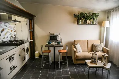 a kitchen and a living room with a couch and a table at Casa de Arriba in Rinlo