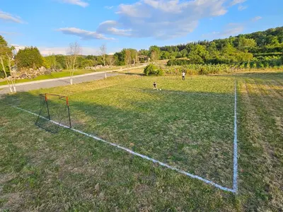 a soccer field with a net in the grass at Casa dos arcos in Sober