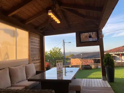a screened in porch with a table and a couch at Casa dos arcos in Sober