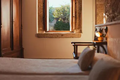 a bedroom with a bed and a window at Casa Do Romualdo in Vilela