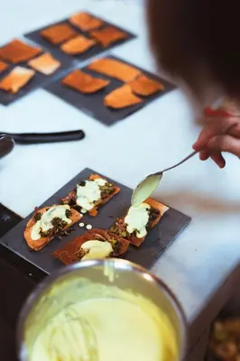a person is eating food on a plate with a spoon at Casa Do Romualdo in Vilela