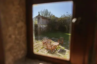 a view of a backyard with a table and chairs at Casa Do Romualdo in Vilela