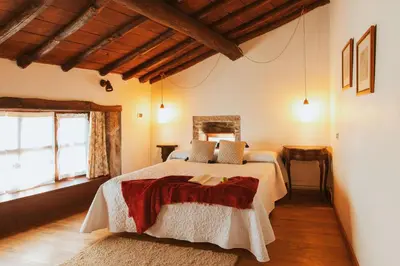 a bedroom with a large bed in a room at Casa Do Romualdo in Vilela