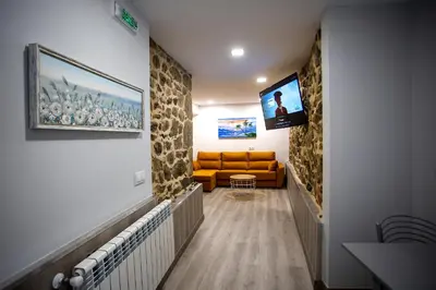 a hallway with a living room with a couch and a television at Apartamentos Casa dos Arcos in Sober