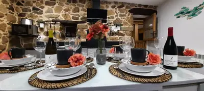 a table with plates and wine bottles and glasses at Apartamentos Casa dos Arcos in Sober