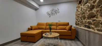 a living room with a couch and a table at Apartamentos Casa dos Arcos in Sober