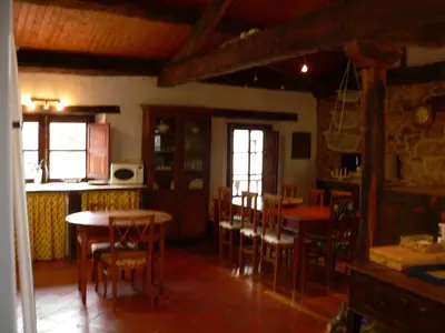 a kitchen and dining room with tables and chairs at El Taller De La Seda in Avedillo de Sanabria