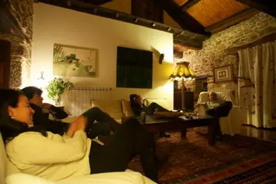 a group of people sitting in a living room at El Taller De La Seda in Avedillo de Sanabria